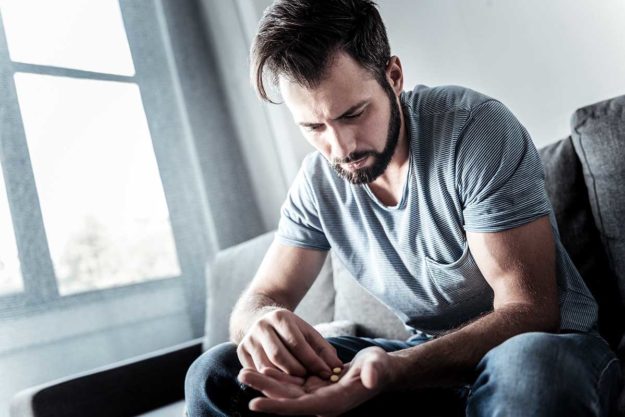 man thinking about recovering addict programs